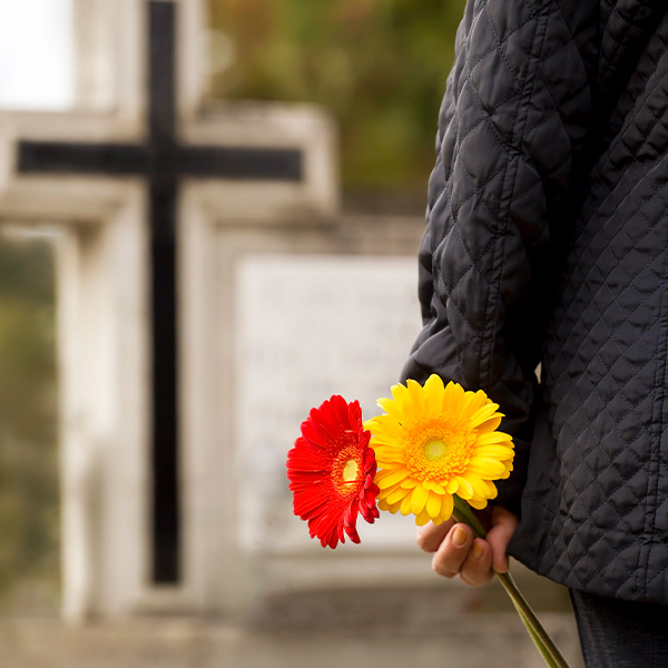 Cross and flowers in the cemetery